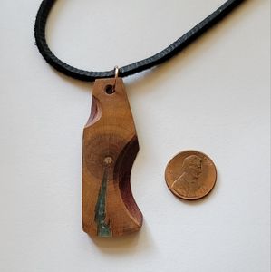 African Padauk and plum wood and resin pendant with black leather cord
